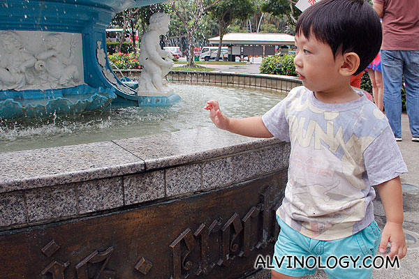 Asher walking round and round the fountain 