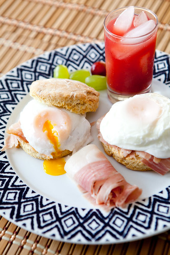 Homemade goose fat biscuits topped with sliced Johnston Country Ham and poached eggs