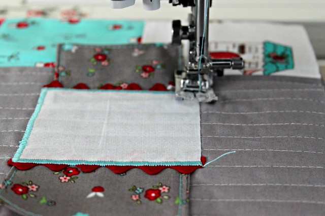 20 Use your machines applique stitch or zig zag stitch to sew the windows and door in place