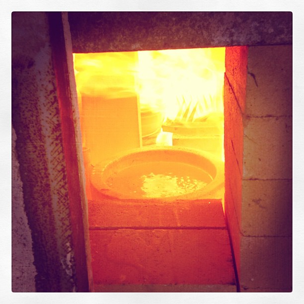 Hot glass in the wood kiln for glassblowing tomorrow morning.