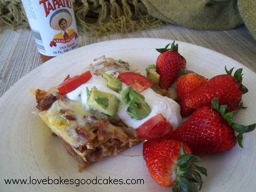 Mexican Breakfast Casserole with strawberries on plate.