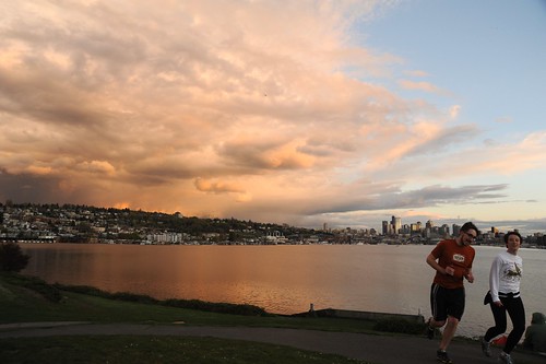 Pink and gray storm edge, clouds, blue sky, reflection in Lake Union, joggers, as seen from Gasworks Park, Capitol Hill, City of Seattle, Washington, USA by Wonderlane