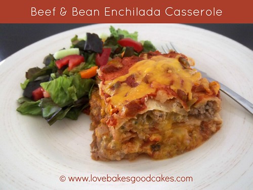 Beef & Bean Enchilada Casserole with green salad on white plate with fork.