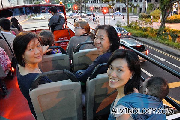 Rachel, Asher, my mum and my aunt smiling for the camera on the bus top