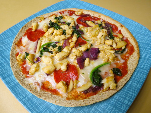 tortilla pizza with chicken sausage, turkey pepperoni, spinach, onion and garlic