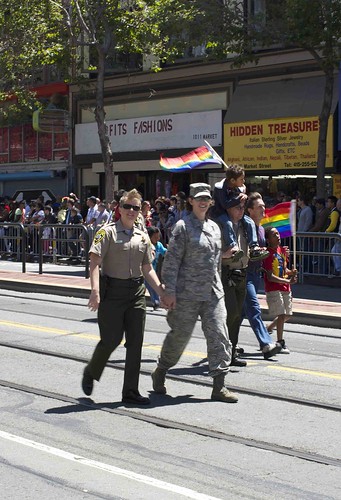 Sheriff's officer walking hand in hand with member of the military