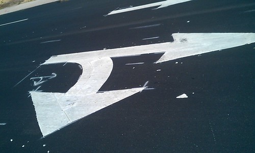 Poorly painted arrows on street