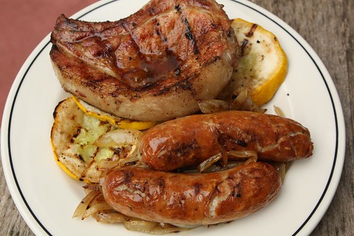 Grilled Veal Sausage with Caramelized Onion, Grilled Zucchini, and Bone-in Pork Chop