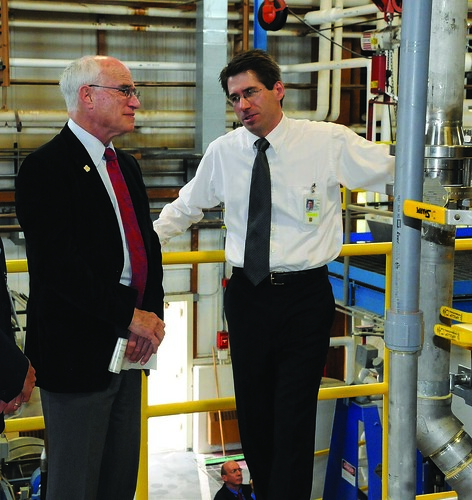 Forest Product Lab chemical engineer Rick Reiner (right) shows Under Secretary Sherman the new nanocellulose pilot plant.
