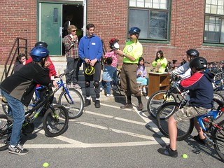 Bike Newton Certified Safety Instructor explaining helmet fit to youth
