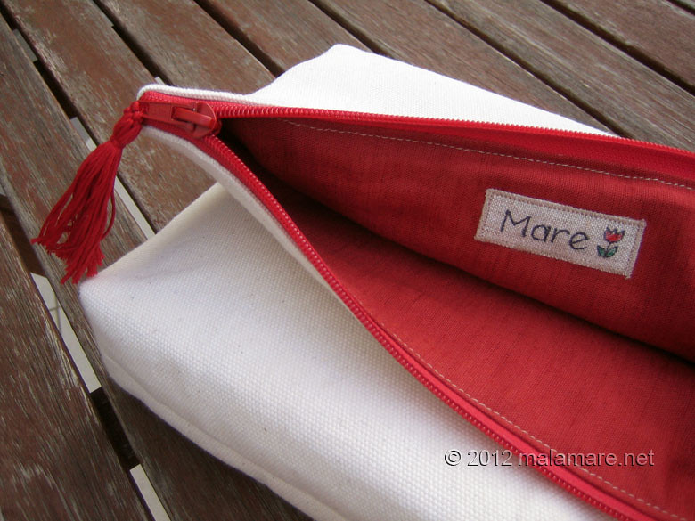 foldover cotton clutch with red hand embroidery inside