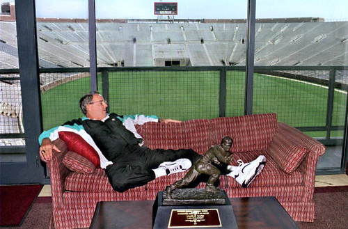 Bobby Bowden relaxing with Charlie Ward's Heisman trophy: Doak Campbell Stadium, Tallahassee