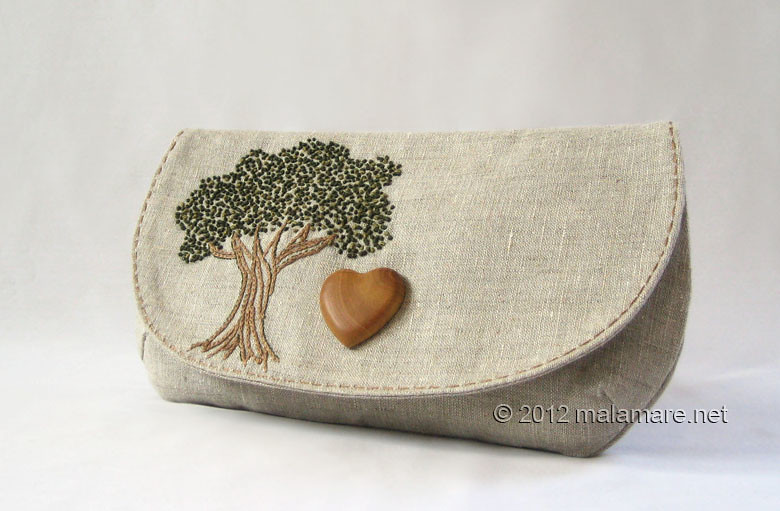 natural linen fabric clutch bag with olive wood heart and hand embroidered tree motif
