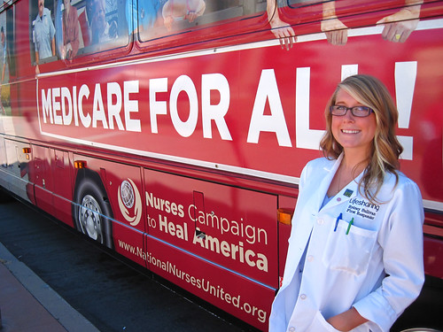 Volunteer Nursing student in front of the Medicare For All bus