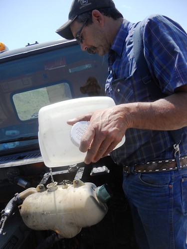 After over heating Dad adds water to his truck