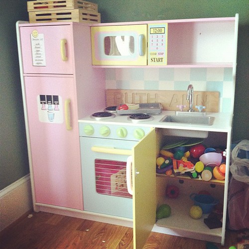 I thought the play kitchen looked unusually clean...until I opened the cabinet...Ruth Ann has adopted her Daddy's favorite method of cleaning!