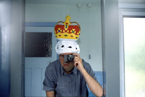 Reflected self-portrait with a Kiev 35A camera and inflatable crown by pho-Tony