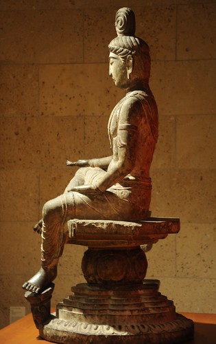 Bodhisattva side view: open hand, palm up, top knot, seated in posture of royal ease, left foot on a lotus, wearing a mala, flowing garments, on mandala seat, statue, 8th Century, Tang Dynasty, Limestone, Art Institute of Chicago, Illinois, USA by Wonderlane