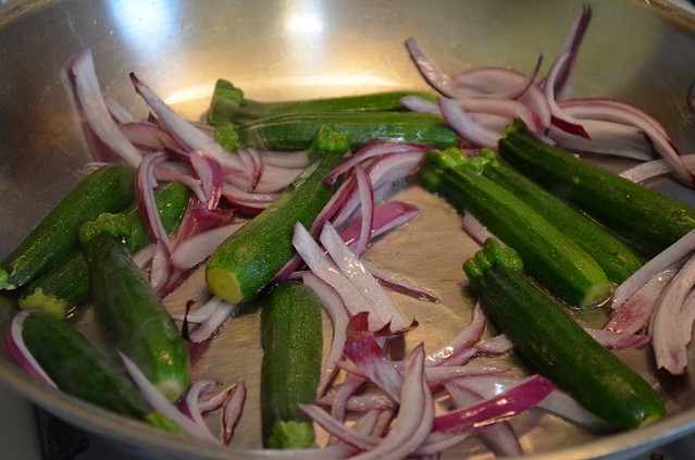 zucchini and red onion in saute pan
