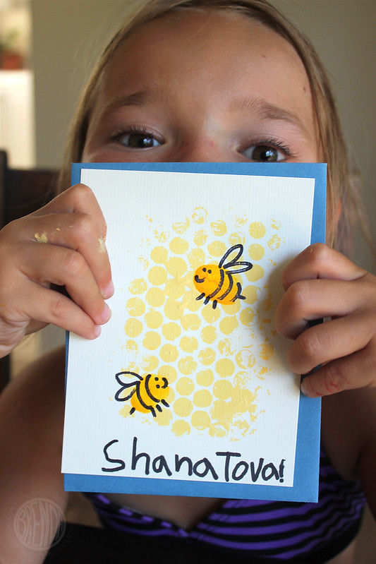 Girl with handmade Shana Tova card with painted Bees and honeycomb for Rosh Hashanah!