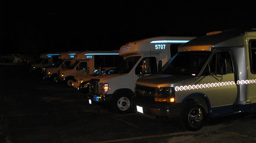 Paratransit buses in the rear parking lot at 5:40 AM.  Glenview Illinois.  September 2012. by Eddie from Chicago