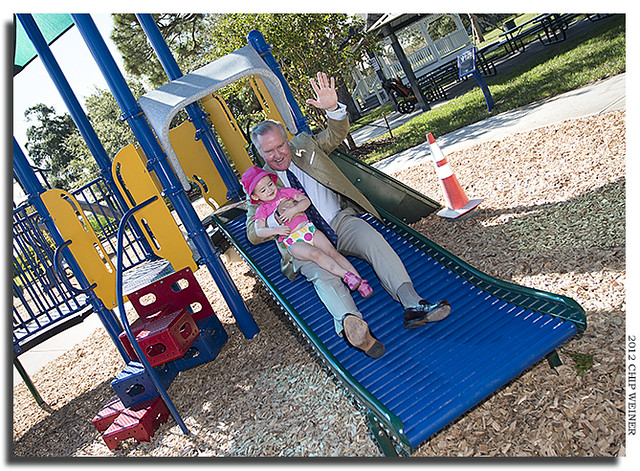 Mayor Bob Buckhorn tries out a slide at the refurbished ballast point Park with two-year-old Selah Repaskey