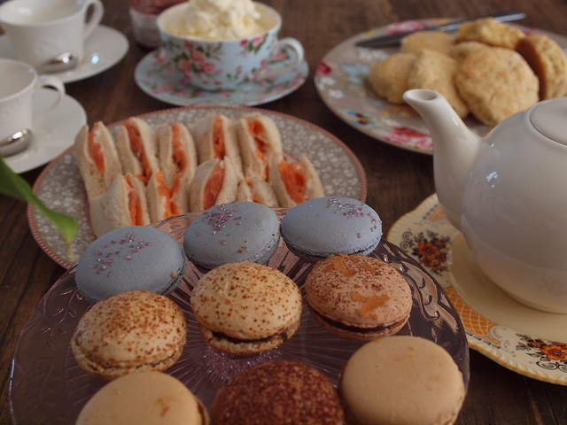 smoked salmon sandwiches, macarons, scones with the works