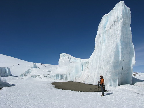A team member stands by a glacier