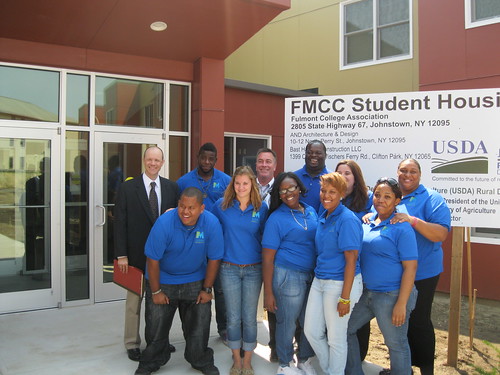 Deputy Under Secretary for Rural Development Doug O’Brien (left) with students from Fulton Montgomery Community College.  The group is standing in front of the new, USDA-funded dormitory.
