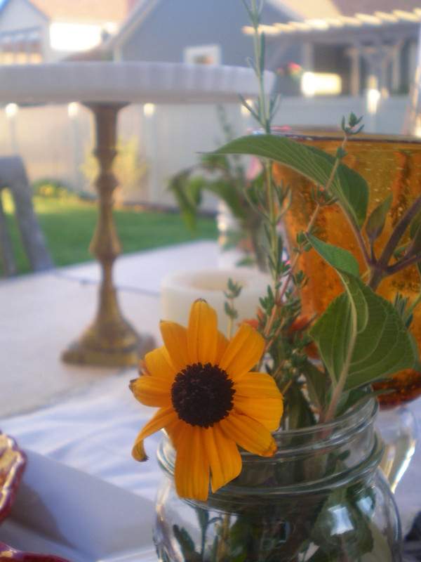 sunflowers in mason jars with herbs in outdoor fall tablescape- Karins Kottage