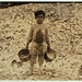 Manuel, the young shrimp-picker, five years old, and a mountain of child-labor oyster shells behind him. He worked last year. Understands not a word of English. Dunbar, Lopez, Dukate Company.  (LOC)