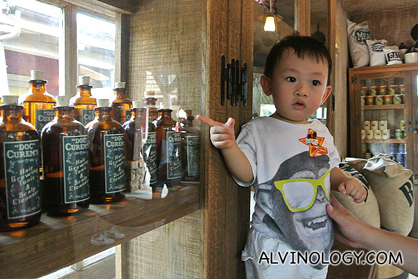 Asher pointing at some items on the shelves