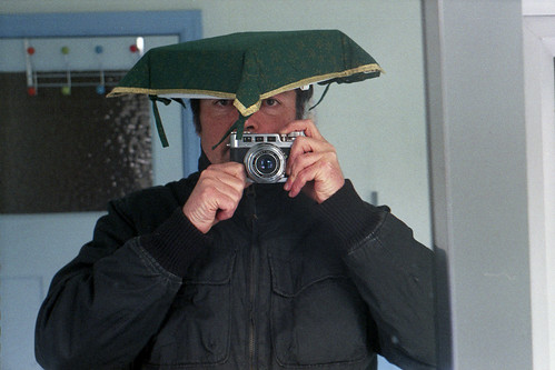 reflected self-portrait with Diax 1a camera and green four cornered hat by pho-Tony