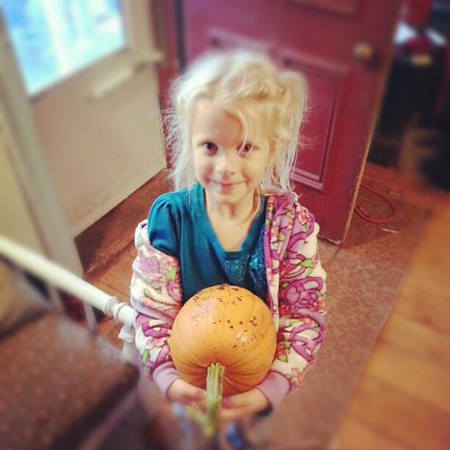 Oh so very proud of her self grown pie pumpkin.