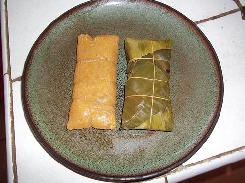 A photo of pasteles, which are made from ground banana stuffed with meat or chicken, wrapped in a banana leaf and cooked.  These were prepared using bananas donated from the research station.