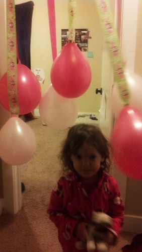 Running through her birthday balloons