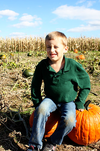 Nathan-sitting-on-two-pumpkins