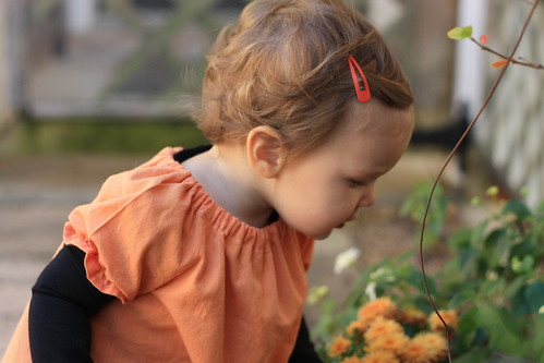 sweet girl smelling the flowers
