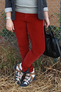 '80s hipster outfit: red corduroys by Pilcro, sneaker wedges, gray sweatshirt, gray blazer, knubbly loop scarf from anthropologie green wool hat from Topshop, studded-bottom bag