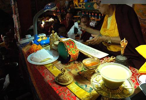 Tea in a jade cup, Buddhist impliments on his table, pecha, mandala offering of the ku, body of the Buddha, His Holiness Jigdal Dagchen Sakya, high lama of the Sakya order, Sakya Lamdre, Tharlam Monastery, Boudha, Kathmandu, Nepal by Wonderlane