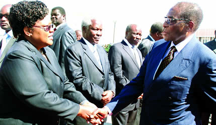 Republic of Zimbabwe President Robert Mugabe says farewell to Vice President Joice Mujuru while he left for the Comesa Summit in Kampala. Zimbabwe is at the forefront of advocating African unity. by Pan-African News Wire File Photos