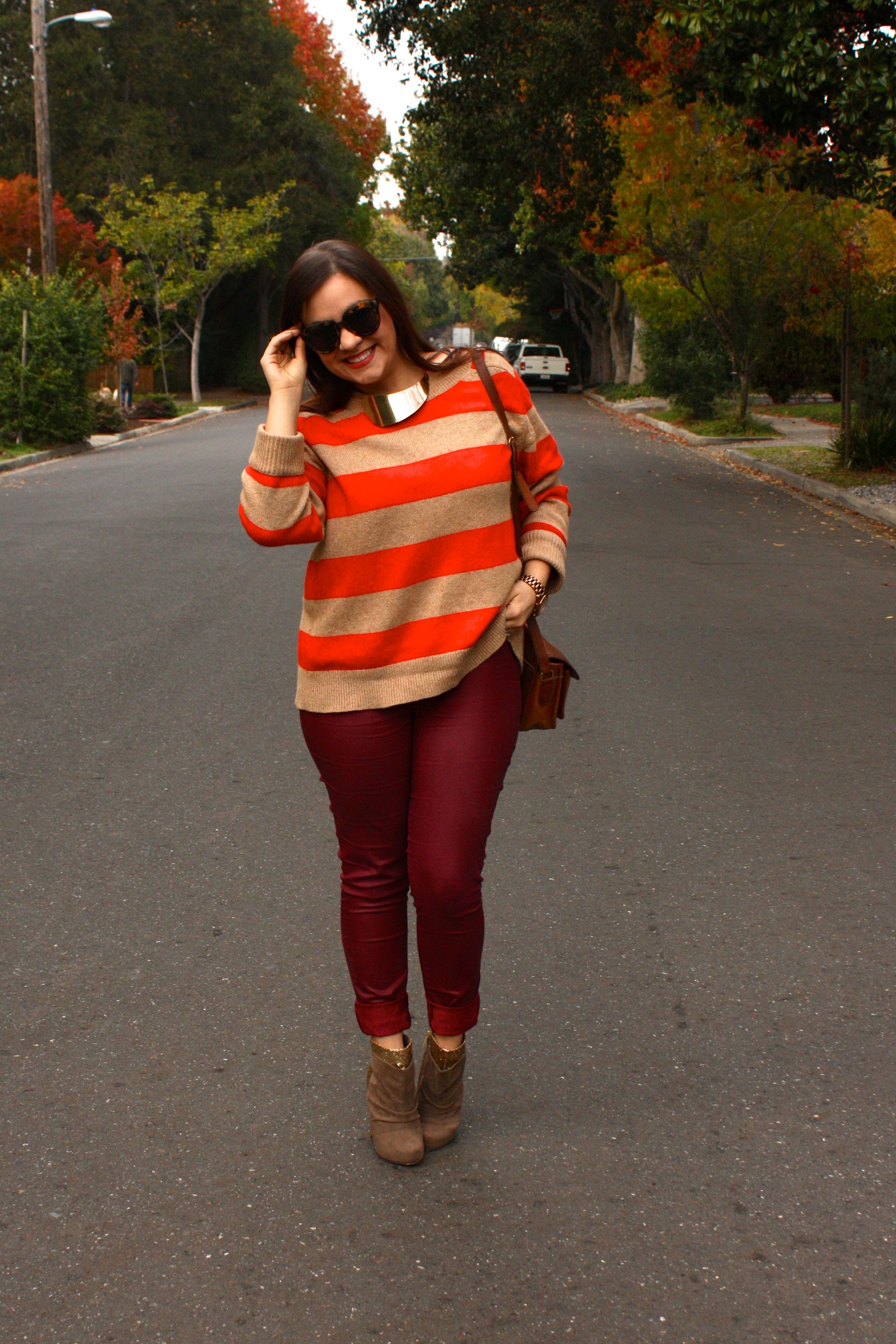 burgundy waxed jeans with orange striped lands end sweater and brown coach bag
