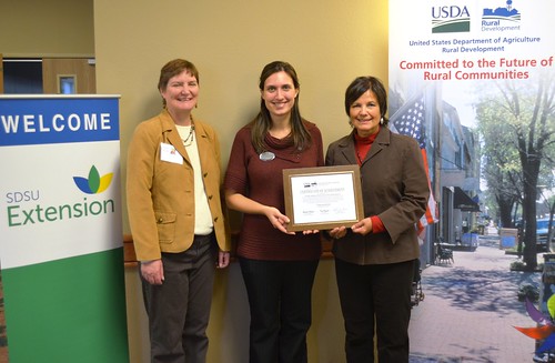 South Dakota State Director Elsie Meeks presents funds to South Dakota State University Extension for an online Local Foods Center while attending the 2012 South Dakota Local Foods Conference.  Pictured left to right, Dr. Rhoda Burrows and Chris Zdorovtsov, SDSU Extension; and State Director Meeks.