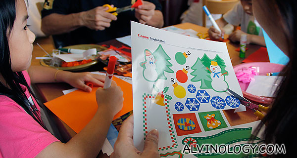 Cutting out Christmas themed decors from Canon Creative Park, printed using the Canon PIXMA
