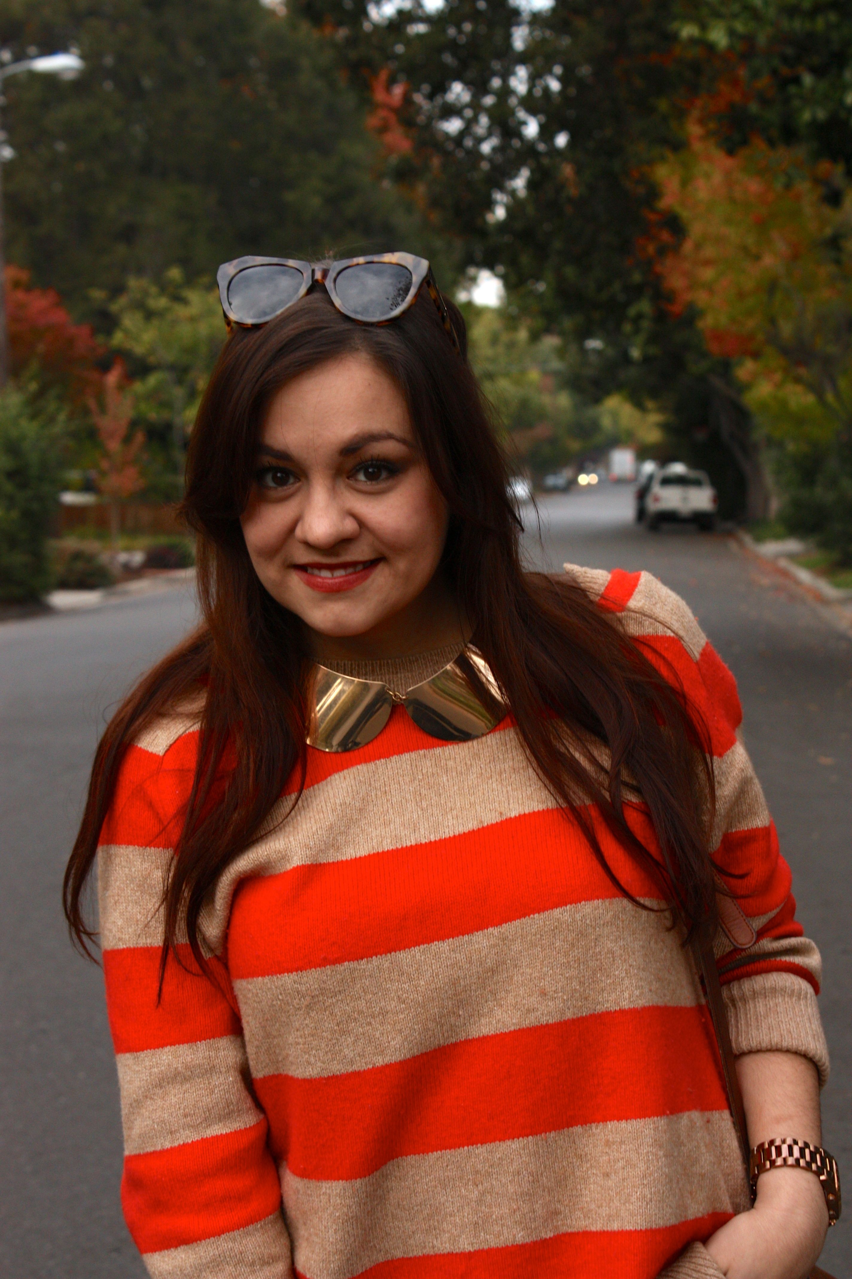 orange striped sweater with gold peter pan collar necklace and karen walker number one sunglasses