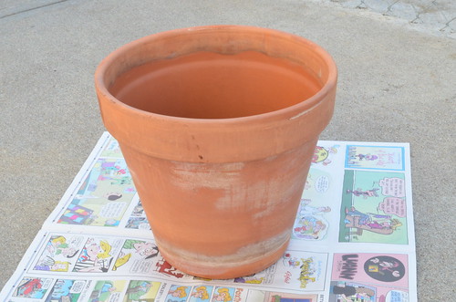 Painted Santa planter filled with pine cones
