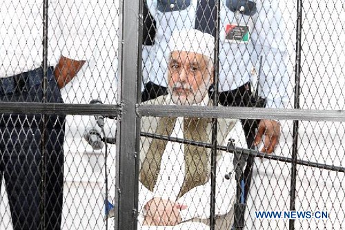 Prime Minister Al-Baghdadi Ali al-Mahmoudi sits in a cage. The former premier of Libya under Col. Muammar Gaddafi is to stand trial in a kangaroo court headed by US puppets. by Pan-African News Wire File Photos