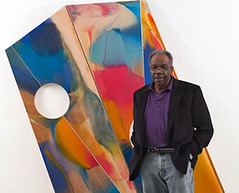 Sam Gilliam in front of one of his paintings (courtesy of U of Louisville College of Arts and Sciences)
