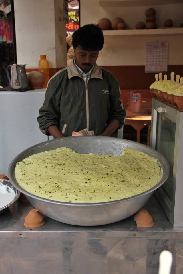 A vendor in Varanasi serving maiyoo - a foam milk dessert