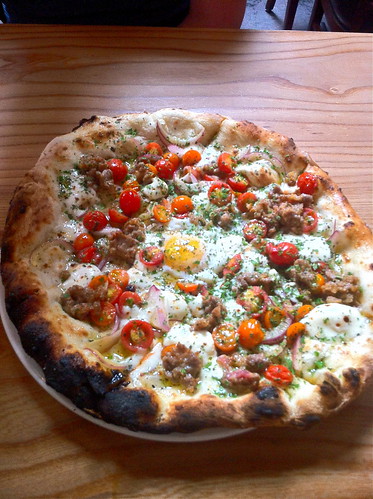 Breakfast pizza w cherry tomatoes and house-made sausage